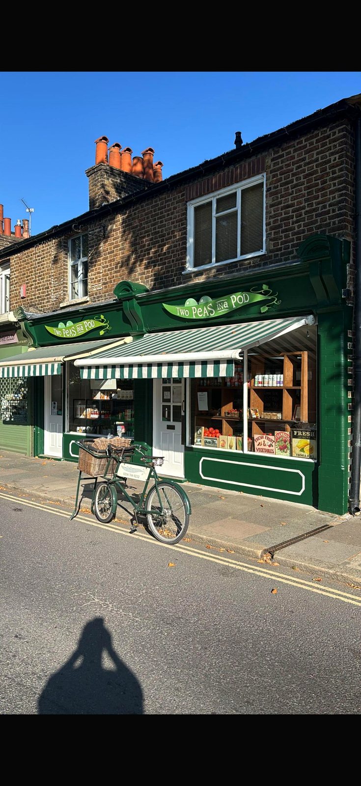 Two Peas in a Pod shop front in Barnes — green awning, bike out front